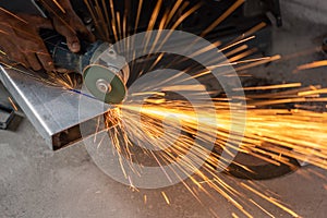 Unsafe construction of Myanmar migrant workers while cutting steel rectangular pipe in construction site