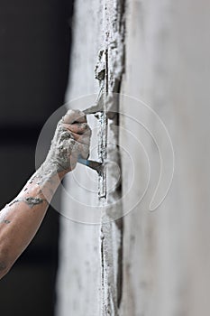 Unsafe construction of Myanmar migrant workers while plastering a wall in construction site , Thailand