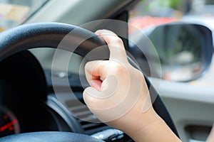 Unsafe hand on the steering wheel during on driving