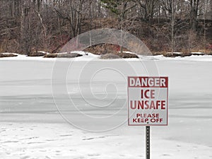 Unsafe ice sign on frozen lake