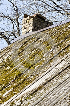 Unsafe roof with broken-down chimney