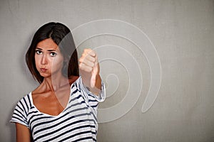 Unsatisfied young lady showing disapproval sign