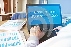 Unsecured Business Loan concept. Man with the laptop