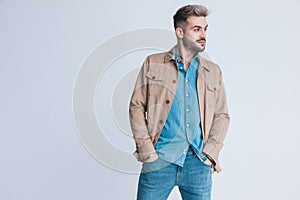 Unshaved casual fashion model in denim shirt looking to side