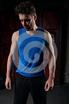 unshaven athletic man in blue tank