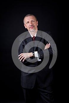 Unshaven businessman with crossed arms