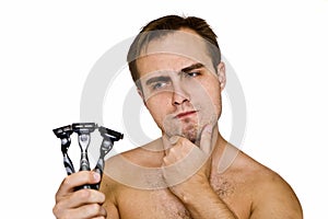 Unshaven guy with three razors