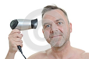 Unshaven man blow drying his short hair