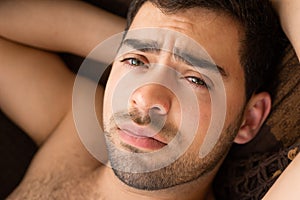 Unshaven, shirtless man looking at camera, natural unedited skin