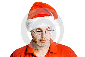 Unshaven slanting eyes Man in Santa hat. Isolated on white. Humo