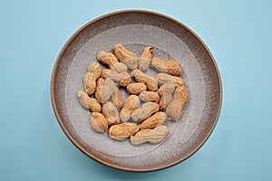 Unshelled dry roasted peanuts in a bowl
