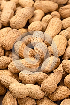 Unshelled peanuts as a background, top view. Food peanut closeup