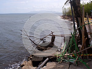 Unsightly abandoned resort bamboo and wooden cottages left untended by the owners due to bankruptcy