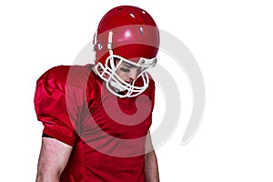 Unsmiling american football player looking down