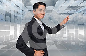 Unsmiling asian businessman pointing