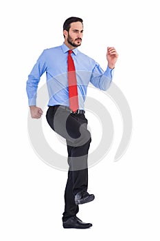 Unsmiling businessman in suit walking