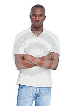 Unsmiling man with arms crossed