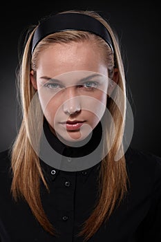 Unsmiling teenager in black photo