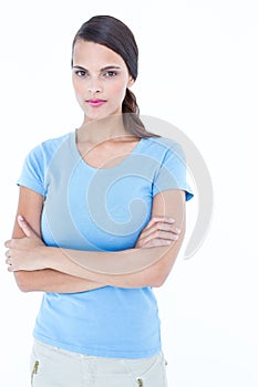 Unsmiling woman looking at camera with arms crossed