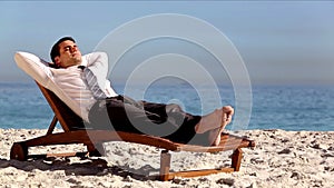 Unstressed businessman relaxing on the beach