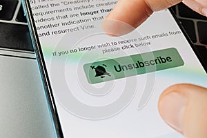 Unsubscribe button on smartphone. Unsubscribe of newsletters