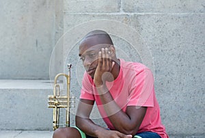 Unsuccessful african american artist with trumpet