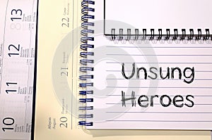 Unsung heroes write on notebook