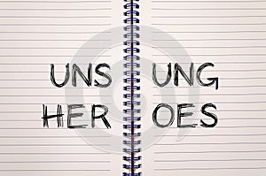 Unsung heroes write on notebook