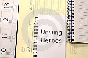 Unsung heroes write on notebook