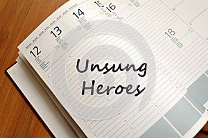 Unsung heroes write on notebook