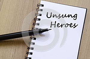 Unsung heroes write on notebook