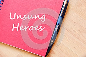 Unsung heroes write on notebook