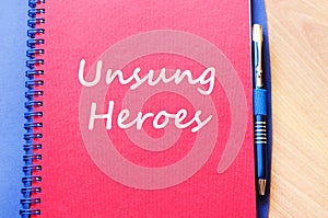 Unsung heroes write on notebook
