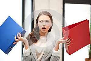 Unsure thinking or wondering woman with folder