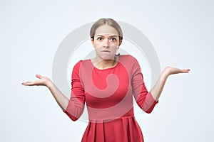 Unsure woman with shrug and hands out gesturing uncertainty photo