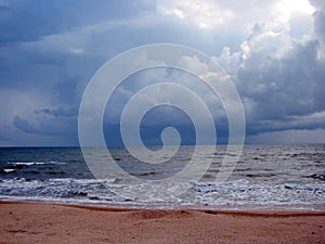 The unsurpassed beauty of the sea coast against the background of rain clouds during a thunderstorm.