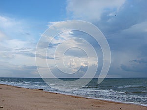 The unsurpassed beauty of the sea coast against the background of rain clouds during a thunderstorm.