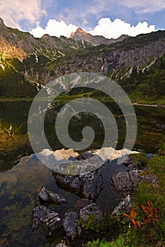 Unterer Gaisalpsee lake at sunset with colorful vegetation from Oberstdorf , Bavaria Germany