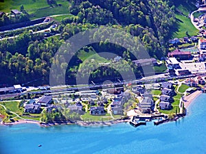 Unterterzen settlement over the shores of Lake Walensee and under the slopes of Glarus Alps - Canton of St. Gallen, Switzerland