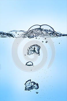 Unterwater bubbles in clear water on blue background