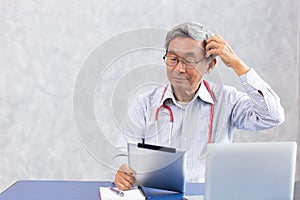 Unthinkable Doctor, Chinese old man using computer tablet with confused complicated with the problem of corona virus health puzzle