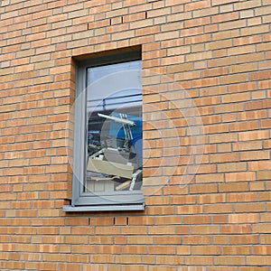 Untidily stacked objects at a window