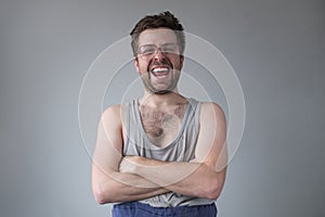 Untidy dressed man in big glasses smiling going crazy of self isolation at home.