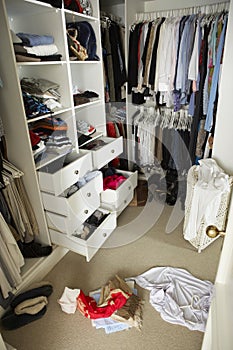 Untidy Teenage Bedroom With Messy Wardrobe photo