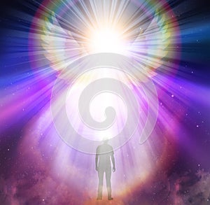 Spiritual guidance, Angel of light and love doing a miracle on sky, rainbow angelic wings photo