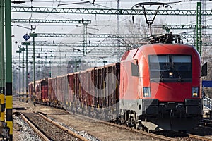 Untitled cargo train locomotive at railway train station. Platform track view. International freight. Cargo shipping
