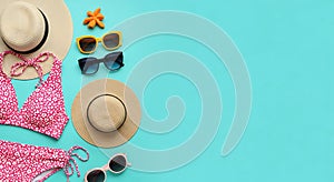 Flat Lay of Summer Beach Essentials with Empty Space on Vibrant Turquoise Background