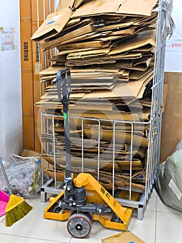 Malaysia November 2 2025 Stacked Cardboard Sheets With Pallet Jack In Storage Area