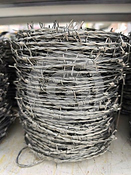 Malaysia November 2 2025 Neatly Stacked Barbed Wire Rolls on Metal Storage Rack