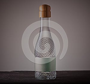 White wine bottle on grey background.